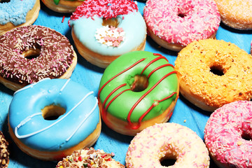 assorted donuts with chocolate frosted, pink glazed and sprinkles donuts.