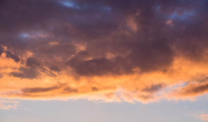 Dark dramatic multicolored clouds during the sunset_