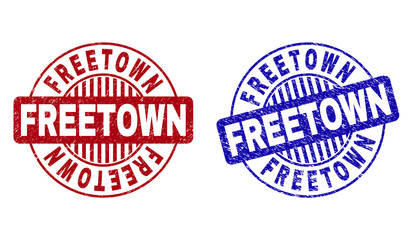 Grunge FREETOWN round stamp seals isolated on a white background. Round seals with grunge texture in red and blue colors. Vector rubber imprint of FREETOWN text inside circle form with stripes.