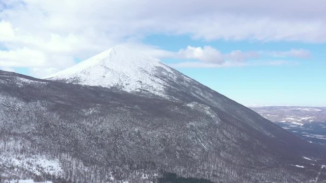 Pyramid shaped peak of mountain Rtanj under snow 4K aerial video