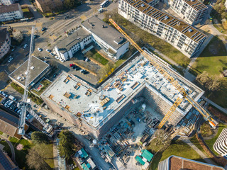 Obraz premium Aerial view of construction site in Switzerland with large yellow crane