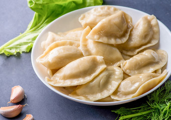 boiled dumplings with filling and sauce on the plate. Steam over a plate