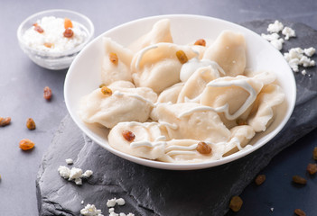 boiled sweet dumplings with filling and sauce on the plate. Steam over a plate