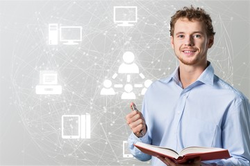 Young male teacher   standing with book