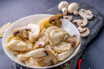 boiled dumplings with filling and sauce on the plate. Steam over a plate
