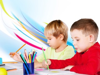 Two little boys studying subject on background