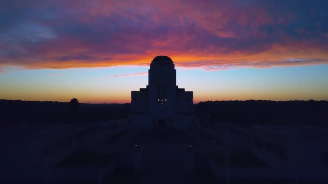 Ascending shot, flying over the abandoned Radio Kootwijk building in the Netherlands during sundown.