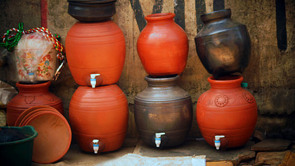 beautiful red and black clay water pot for sale o the  Indian city road 