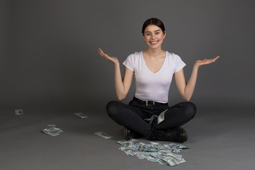 Pretty beautiful girl with brunette hair looking at camera sitting in lotus position