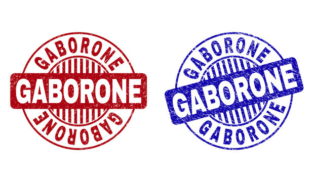 Grunge GABORONE round stamp seals isolated on a white background. Round seals with distress texture in red and blue colors. Vector rubber watermark of GABORONE title inside circle form with stripes.