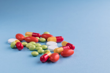 medicines and pills on blue background.