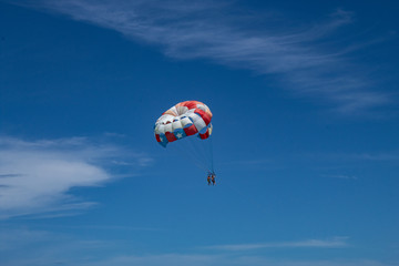 Couple parasailing in Bavaro beach, Punta Cana. Vacation or Holiday concept