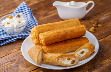 sweet pancakes with stuffing on a decorated table