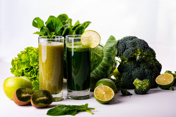 Green smoothie kiwi and cauliflower drinks on white wooden background. Raw food and drink.