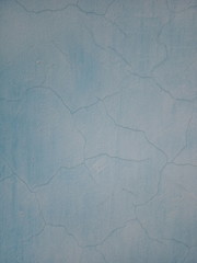 Texture of the old cracked wall. The wall is painted pale blue paint.