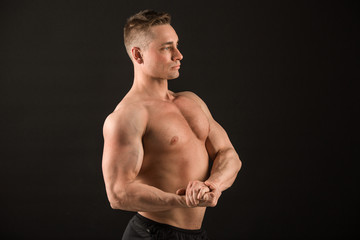 Fototapeta premium handsome muscular man on black background