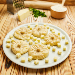 Georgian dumplings Khinkali with cheese, greens and tomato spicy sauce Satsebeli on white plate