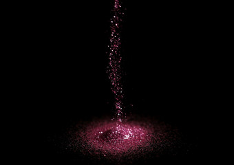 Sprinkling rose glitter on black background, bokeh effect