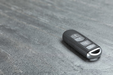 Car smart key on grey background. Space for text