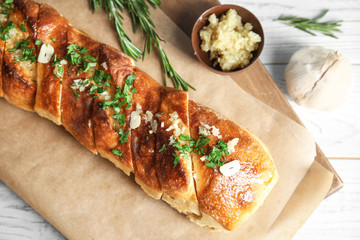 Delicious homemade garlic bread on table, top view