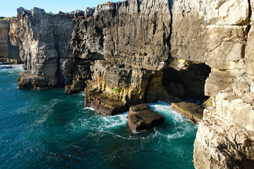 Fototapeta premium Cave in the rocks near the water in the town of Cascais Portugal on the shores of the Atlantic Ocean