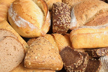 Different kinds of bread as background, closeup