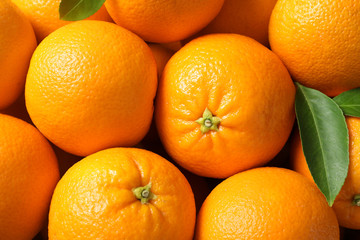 Pile of ripe oranges as background, top view