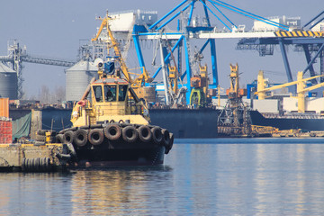 Tugboat is at the pier in the sea port. Cargo port Odessa, Ukraine