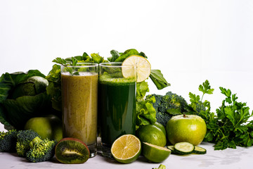 Green smoothie kiwi and cauliflower drinks on white wooden background. Raw food and drink.