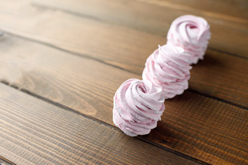 Pink Meringue Marshmallow Zephyr On Wooden Brown Background.Top view. Pink sweet homemade zephyr or marshmallow. Place for text