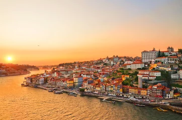 Fotobehang Magnificent sunset over the Porto city center and the Douro river, Portugal. Dom Luis I Bridge is a popular tourist spot as it offers such a beautiful view over the area. © ppohudka