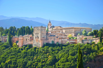 Fototapeta na wymiar Amazing view of Alhambra palace complex in Granada, Spain taken on a sunny day. UNESCO World Heritage Site, significant sample of Islamic architecture and one of Spain's major tourist attractions.