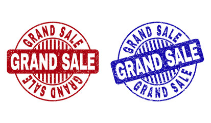 Grunge GRAND SALE round stamp seals isolated on a white background. Round seals with grunge texture in red and blue colors. Vector rubber imprint of GRAND SALE text inside circle form with stripes.