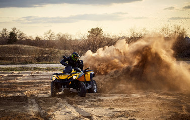 Racing in the sand on a four-wheel drive quad. © Bondariev Volodymyr.