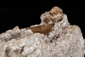 Macro stone Topaz mineral in rock on a black background