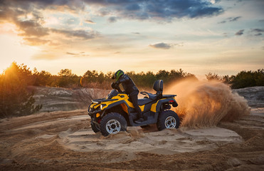 Racing in the sand on a four-wheel drive quad.