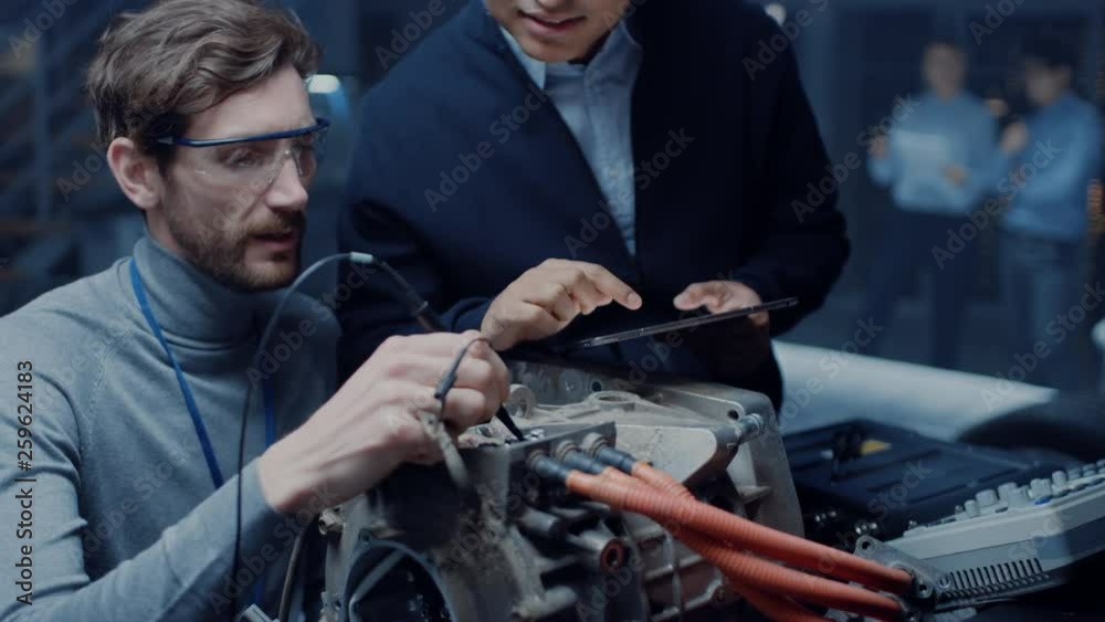 Fototapete two professional automotive engineers with a tablet computer and inspection tools are having a conve