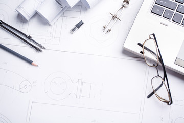 Laptop with several drawing tools on drawings