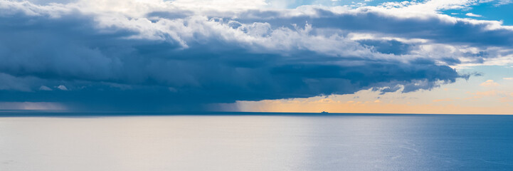 The Mediterranean Sea, bay of Nice, panorama of a storm and a ship in background 