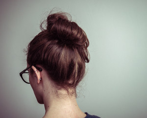 Caucasian woman from behind with brown hair in a ponytail - obrazy, fototapety, plakaty