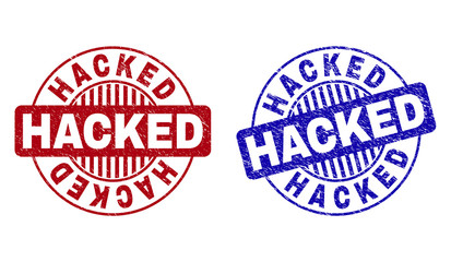 Grunge HACKED round stamp seals isolated on a white background. Round seals with grunge texture in red and blue colors. Vector rubber overlay of HACKED label inside circle form with stripes.
