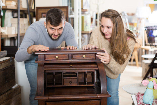 Couple satisfied with purchase of writing cabinet