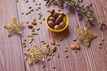 Ester chocolate with nuts on a wooden table