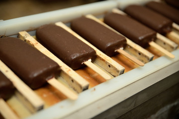The conveyor automatic lines for the production of ice cream. Production of ice-cream at milk factory