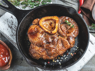  Osso buco cooked veal shank on a portion board closeup