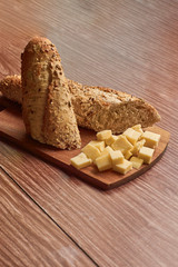 bread and cheese on wooden table