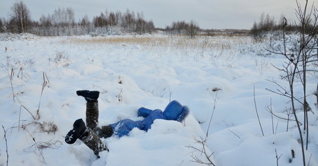 girl in a snowdrift in winter field