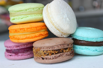 Colorful French or Italian macaroon stack cakes / Macaroon cakes. Assorted macaroon cakes stacked on top of each other on a light background. Copy space. Delicious dessert.