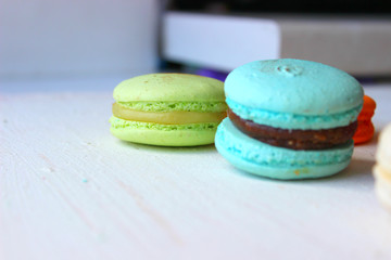 Colorful French or Italian macaroon stack cakes / Macaroon cakes. Assorted macaroon cakes stacked on top of each other on a light background. Copy space. Delicious dessert.