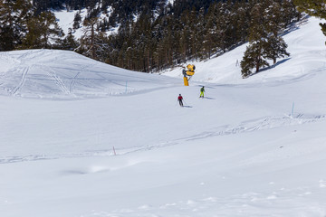 Skiers go down the mountain road